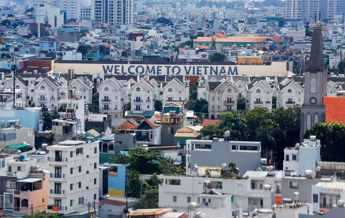 Vietnamese cityscape with a Welcome to Vietnam sign — Vietnam in the AI boom era